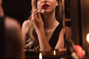 Flirtatious female using red lipstick © Photographee.eu