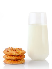 Stack of three homemade peanut butter cookies and glass of milk, isolated on white background