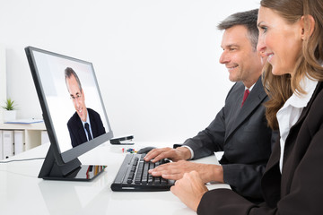 Two Businesspeople In Video Conference