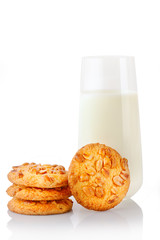 Stack of three homemade peanut butter cookies, single cookie and glass of milk, isolated on white background