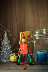 Wooden toy soldier in red uniform decoration and candle