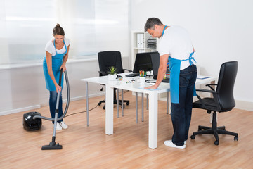 Two Janitors Are Cleaning The Office