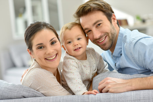 Portrait of happy young couple with baby girl