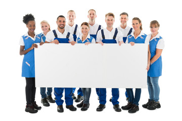 Happy Multiethnic Janitors Holding Blank Billboard