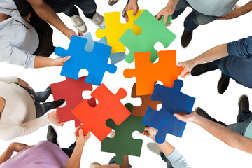 Creative Business People Holding Colorful Puzzle Pieces