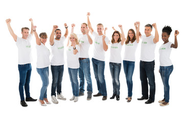 Obraz premium Confident Volunteers With Arms Raised Standing In Row
