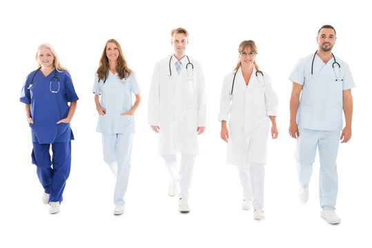 Portrait Of Confident Medical Team Walking In Row