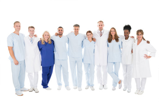 Confident Medical Team Standing With Arms Around