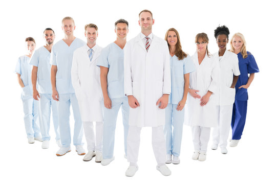 Portrait Of Confident Doctor Standing With His Team