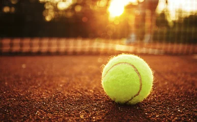 Fotobehang Tennis ball/Close up of tennis ball on clay court. © likoper