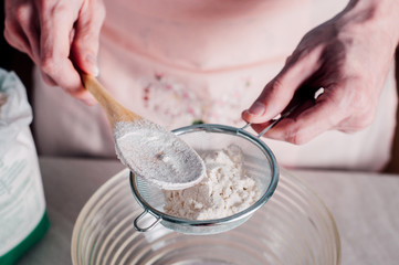 Man sifting flour for pizza dough
