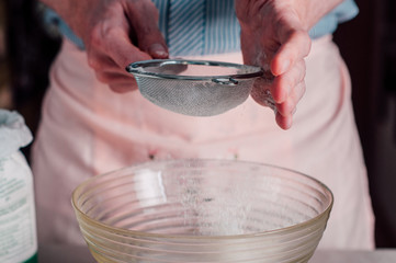 Man sifting flour for pizza dough