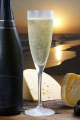 champagne with delicious cheeses on sunset