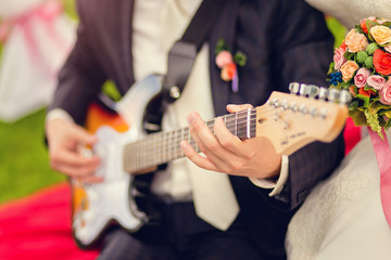 The groom plays guitar