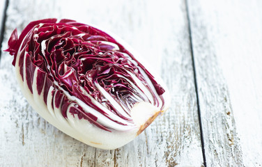 Delicious red chicory salad on a wooden background