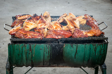 Roasting chicken and pork on Stove © Kris Tan