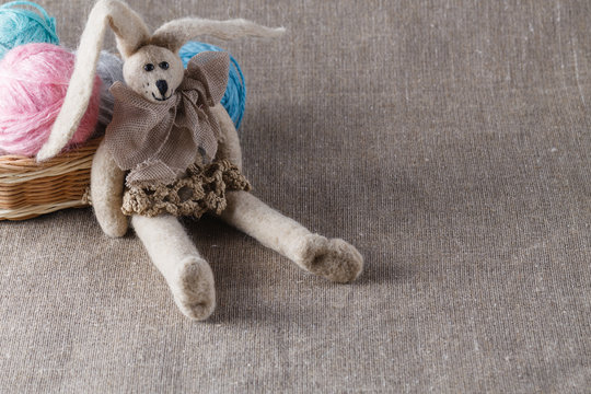 Homemade tilda doll and colored clew in backed
