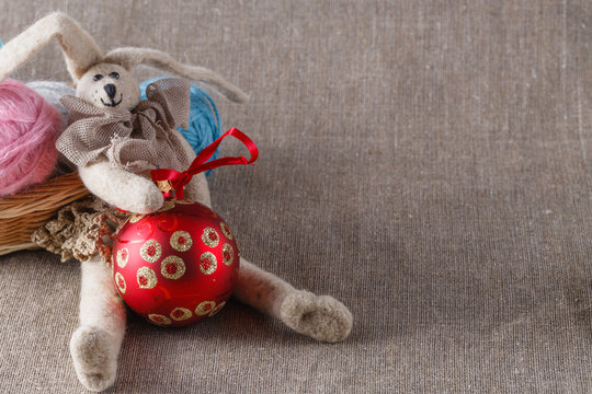 Homemade tilda doll and colored clew in backed