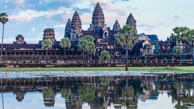 Timelapse of Cambodia landmark Angkor Wat with reflection in water. Panning camera