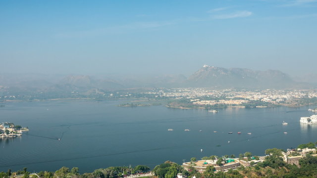 Timelapse of aerial view of Lake Pichola with Lake Palace (Jag Niwas) and Jag Mandir (Lake Garden Palace) with panning. Udaipur, Rajasthan, India