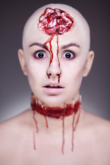 Horrible scary zombie woman. Halloween makeup.