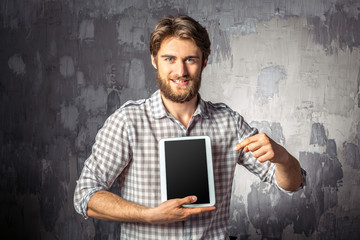 Young man holding digital tablet