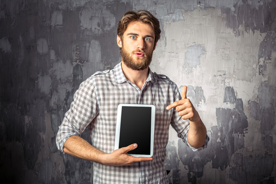 Young man holding digital tablet