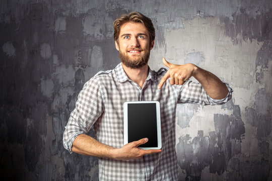Young man holding digital tablet