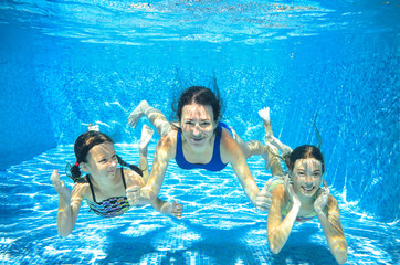 Family swim in pool underwater, happy active mother and children have fun in water, kids sport on...