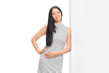 Woman posing in a white dress with black stipes