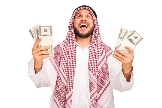 Overjoyed Arab holding stacks of money