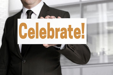 Obraz premium celebrate sign is held by businessman concept