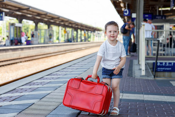 Cute little girl on a railway station.