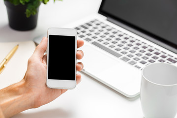Cropped shot of a man's hands using a laptop at home
