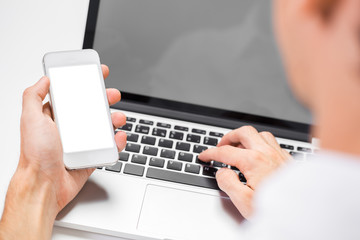 Cropped shot of a man's hands using a laptop at home