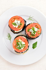 Baked slices of eggplant with tomato and curd cheese