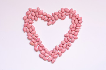 Pink dragees in heart shape