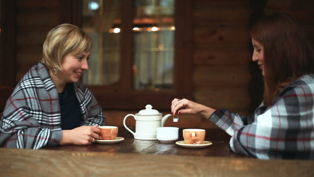 Girls talk and drink their tea porcelain teapot