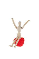 wooden model doctor holding a heart symbol