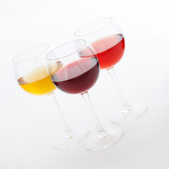 Wine bar, three glasses of wine unusual perspective on white background.