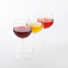 Wine bar, three glasses of wine unusual perspective on white background.