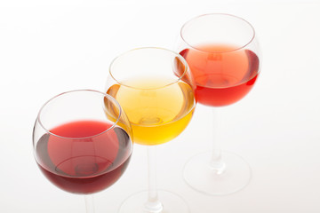 Wine bar, three glasses of wine unusual perspective on white background.