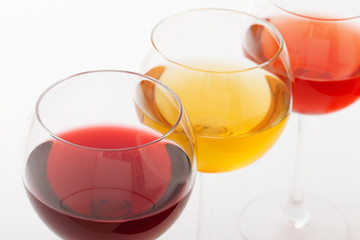 Wine bar, three glasses of wine unusual perspective on white background.