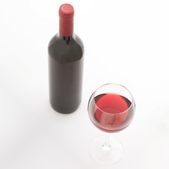Glass and bottle of red wine. Top view unusually on white background.