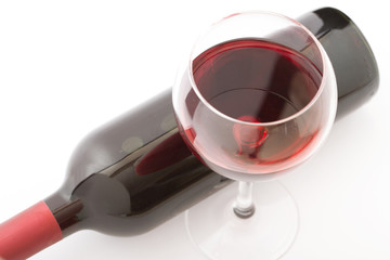 Glass and bottle of red wine. Top view unusually on white background.