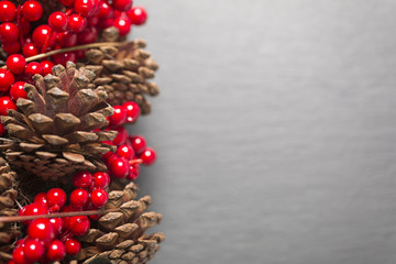 Pine cones and red holly berries