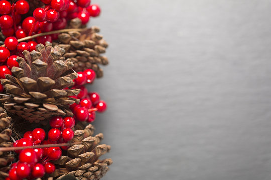 Pine cones and red holly berries