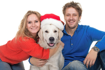  family with dog Labrador in Santa Claus's cap