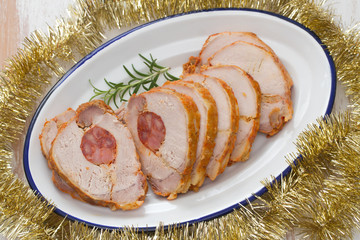 baked meat with smoked sausage on white dish