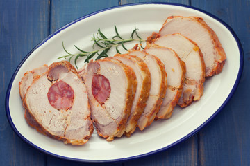 pork with chourico on white dish on blue wooden background